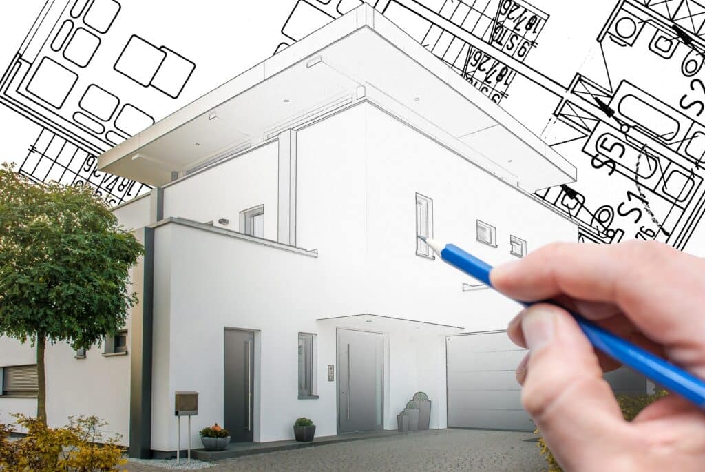 Hand zeichnet modernes Haus auf Bauplan | Anwalt Baurecht Nürnberg