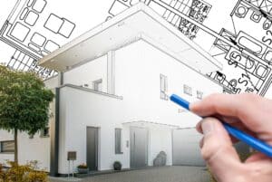 Hand zeichnet modernes Haus auf Bauplan | Anwalt Baurecht Nürnberg